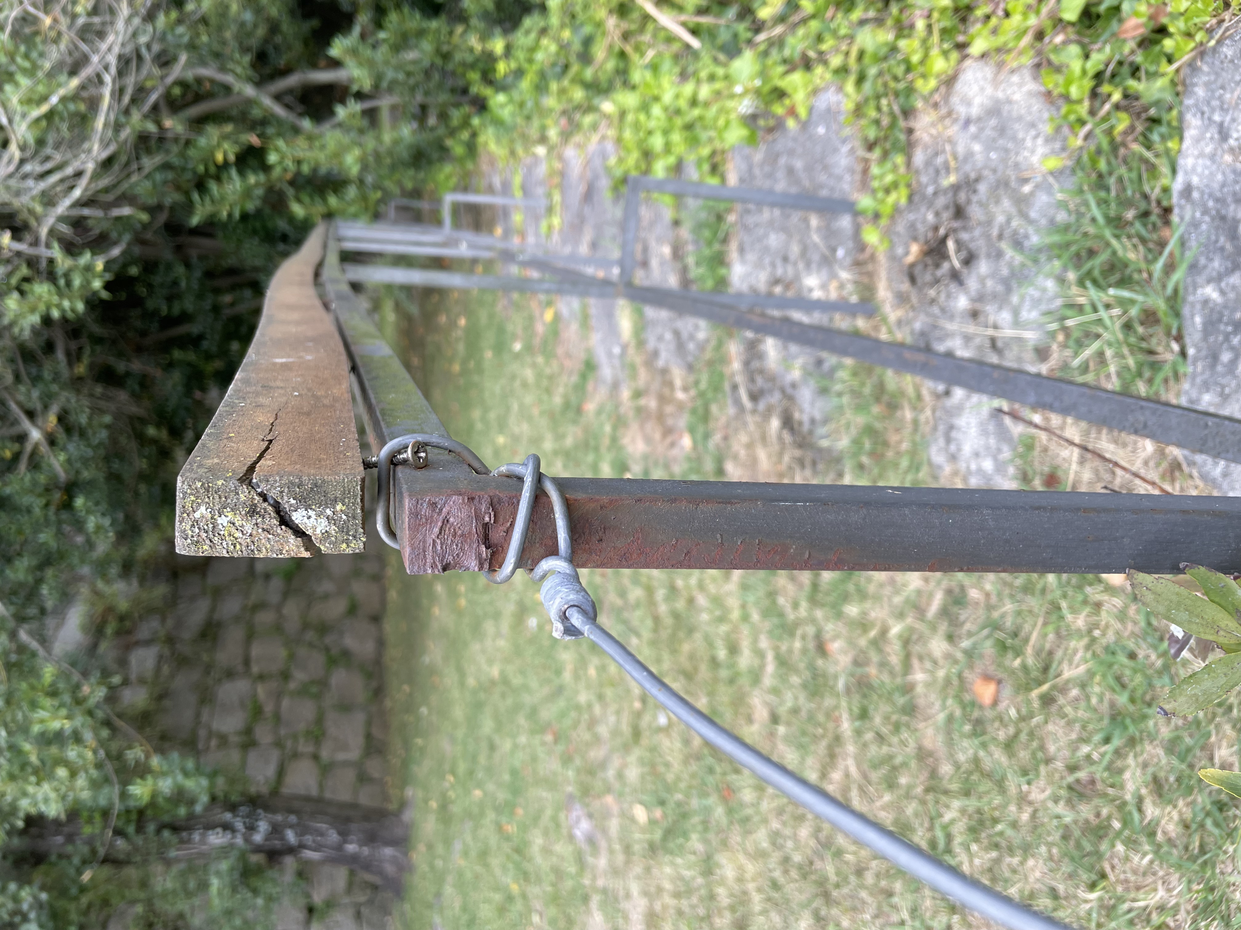 handrail attached with wire and a screw